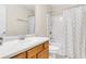 Clean bathroom featuring a shower-tub combo with a white tile surround and a wooden vanity with a white countertop at 252 Island Green Rd, Goose Creek, SC 29445