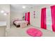 Colorful and fun bedroom with pink rug and curtains, perfect for a space or guest room at 252 Island Green Rd, Goose Creek, SC 29445