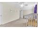 Well-lit bedroom with a white crib, ceiling fan, and neutral decor, providing a serene and comfortable environment at 252 Island Green Rd, Goose Creek, SC 29445