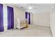 Cozy bedroom with a neutral carpet, a white crib, and a window with vibrant purple curtains, creating a peaceful atmosphere at 252 Island Green Rd, Goose Creek, SC 29445
