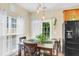 Cozy dining area with natural light, modern lighting fixtures, and black appliances, perfect for everyday meals at 252 Island Green Rd, Goose Creek, SC 29445