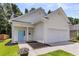 Well-maintained single-Gathering home featuring a bright blue door, two-car garage, and landscaped front at 252 Island Green Rd, Goose Creek, SC 29445