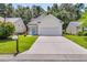 Charming single-Gathering home featuring a bright blue door, two-car garage, and well-maintained lawn at 252 Island Green Rd, Goose Creek, SC 29445