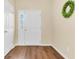 Bright foyer featuring hardwood floors and a white entry door with sidelight window at 252 Island Green Rd, Goose Creek, SC 29445