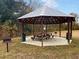 Community picnic area with a covered gazebo featuring picnic tables and BBQ grills, perfect for outdoor gatherings at 252 Island Green Rd, Goose Creek, SC 29445
