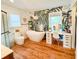 Modern bathroom with freestanding tub, vanity, and tropical-themed wallpaper at 27 Fitzroy Dr, Charleston, SC 29414