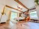 Well-lit bedroom featuring beamed ceiling, accent wall, and herringbone flooring at 27 Fitzroy Dr, Charleston, SC 29414