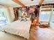 Bright bedroom with striking wallpaper, beamed ceiling, and herringbone floors at 27 Fitzroy Dr, Charleston, SC 29414