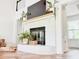 Living room featuring a white brick fireplace with wooden mantle, herringbone floors and potted plants at 27 Fitzroy Dr, Charleston, SC 29414