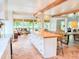 Open-concept kitchen and living area with an island, wood beams, and comfortable seating in a light and airy setting at 27 Fitzroy Dr, Charleston, SC 29414