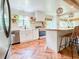 Stylish kitchen with herringbone floors, white cabinets, stainless steel appliances, and rattan pendant lights at 27 Fitzroy Dr, Charleston, SC 29414