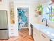 Chic kitchen with stainless steel refrigerator, white cabinets, herringbone floors, and a colorful walk-in pantry at 27 Fitzroy Dr, Charleston, SC 29414
