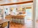 Bright kitchen features white cabinetry, center island with bar seating, designer lighting and open shelving at 27 Fitzroy Dr, Charleston, SC 29414