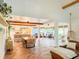 Spacious open concept living room with wood floors, kitchen, dining area, and sunroom access at 27 Fitzroy Dr, Charleston, SC 29414