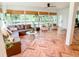 Bright and open sunroom with leather sectional, wicker furniture, and several windows providing gorgeous view at 27 Fitzroy Dr, Charleston, SC 29414