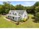 Aerial view of a charming two-story home with a metal roof and covered porch surrounded by lush greenery at 2962 Anchor Watch Dr, Wadmalaw Island, SC 29487