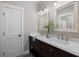 Elegant bathroom featuring double sinks, quartz counters, and decorative mirrors at 2962 Anchor Watch Dr, Wadmalaw Island, SC 29487