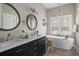 Bathroom with modern tub, double vanity sink, and stylish fixtures and decor at 2962 Anchor Watch Dr, Wadmalaw Island, SC 29487