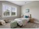 Sunlit bedroom boasting neutral tones, a charming bed, and serene outdoor views at 2962 Anchor Watch Dr, Wadmalaw Island, SC 29487