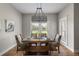 Charming dining room featuring a wooden table, upholstered chairs, and ample natural light at 2962 Anchor Watch Dr, Wadmalaw Island, SC 29487