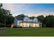 Charming two-story home with wraparound porch, lush lawn, and inviting curb appeal at 2962 Anchor Watch Dr, Wadmalaw Island, SC 29487