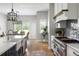Well-appointed kitchen with a spacious island, stainless steel appliances, and a view into the adjacent dining room at 2962 Anchor Watch Dr, Wadmalaw Island, SC 29487