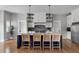 Beautiful kitchen featuring a center island with seating, custom cabinets, pendant lights, and modern appliances at 2962 Anchor Watch Dr, Wadmalaw Island, SC 29487