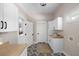 Well-organized laundry room with modern appliances, custom cabinets, and stylish flooring at 2962 Anchor Watch Dr, Wadmalaw Island, SC 29487