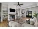Bright and spacious living room with hardwood floors, ceiling fan, and fireplace at 2962 Anchor Watch Dr, Wadmalaw Island, SC 29487