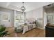 Spacious bedroom with tray ceiling, hardwood floors, lots of natural light and plant accent at 2962 Anchor Watch Dr, Wadmalaw Island, SC 29487