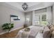 Comfortable main bedroom with hardwood floors, accent lighting, and natural light at 2962 Anchor Watch Dr, Wadmalaw Island, SC 29487