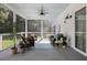 Relaxing screened porch featuring wicker furniture, ceiling fan, and view of yard at 2962 Anchor Watch Dr, Wadmalaw Island, SC 29487