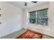 Clean bedroom offers a large window, ceiling fan, neutral paint, and a small red rug at 402 Pine Bluff Dr, Summerville, SC 29483