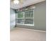 Calming bedroom features light gray walls, a floral decal, ceiling fan, and large window at 402 Pine Bluff Dr, Summerville, SC 29483