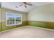 Bright bedroom featuring a ceiling fan, large window, and neutral carpet at 402 Pine Bluff Dr, Summerville, SC 29483