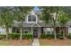 Charming townhouse featuring a well-kept lawn, lush bushes, and welcoming entrance at 402 Pine Bluff Dr, Summerville, SC 29483