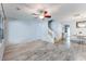 Open-concept living space with wood floors, ceiling fan, stairs, and a dining area at 402 Pine Bluff Dr, Summerville, SC 29483