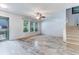 Bright, airy living room with wood floors, large windows, and staircase at 402 Pine Bluff Dr, Summerville, SC 29483