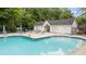 Community pool and changing area has ample chairs and is surrounded by trees at 402 Pine Bluff Dr, Summerville, SC 29483