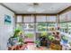 Cozy sunroom with views of the lake, potted plants, and a ceiling fan for relaxation at 402 Pine Bluff Dr, Summerville, SC 29483