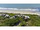 Stunning aerial view showcases beachside condos surrounded by lush trees and the pristine ocean at 4303 Sea Forest Dr, Kiawah Island, SC 29455