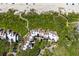 Overhead aerial view capturing coastal condos, lush vegetation and a scenic pathway down to the beach at 4303 Sea Forest Dr, Kiawah Island, SC 29455