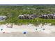 Expansive aerial highlights oceanfront condos next to the sandy beach, edged by dense, green foliage at 4303 Sea Forest Dr, Kiawah Island, SC 29455