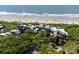 Breathtaking aerial view of the beachside condos surrounded by lush greenery and the pristine ocean at 4303 Sea Forest Dr, Kiawah Island, SC 29455