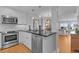 Modern kitchen features stainless appliances, white cabinetry, and granite countertops at 4303 Sea Forest Dr, Kiawah Island, SC 29455