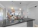Well-lit kitchen features stainless steel appliances, undermount sink, and bar seating overlooking open-plan living space at 4303 Sea Forest Dr, Kiawah Island, SC 29455
