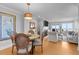 Open-plan living area features a fireplace, dining table, comfortable seating, and abundant natural light at 4303 Sea Forest Dr, Kiawah Island, SC 29455
