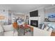 Comfortable living room with fireplace, TV, and views into dining area and kitchen at 4303 Sea Forest Dr, Kiawah Island, SC 29455