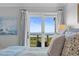 Bright bedroom features ocean views through sliding glass doors onto a balcony at 4303 Sea Forest Dr, Kiawah Island, SC 29455