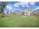 Spacious backyard with a wooden fence, a playset, and green lawn at 452 Minim St, Charleston, SC 29414